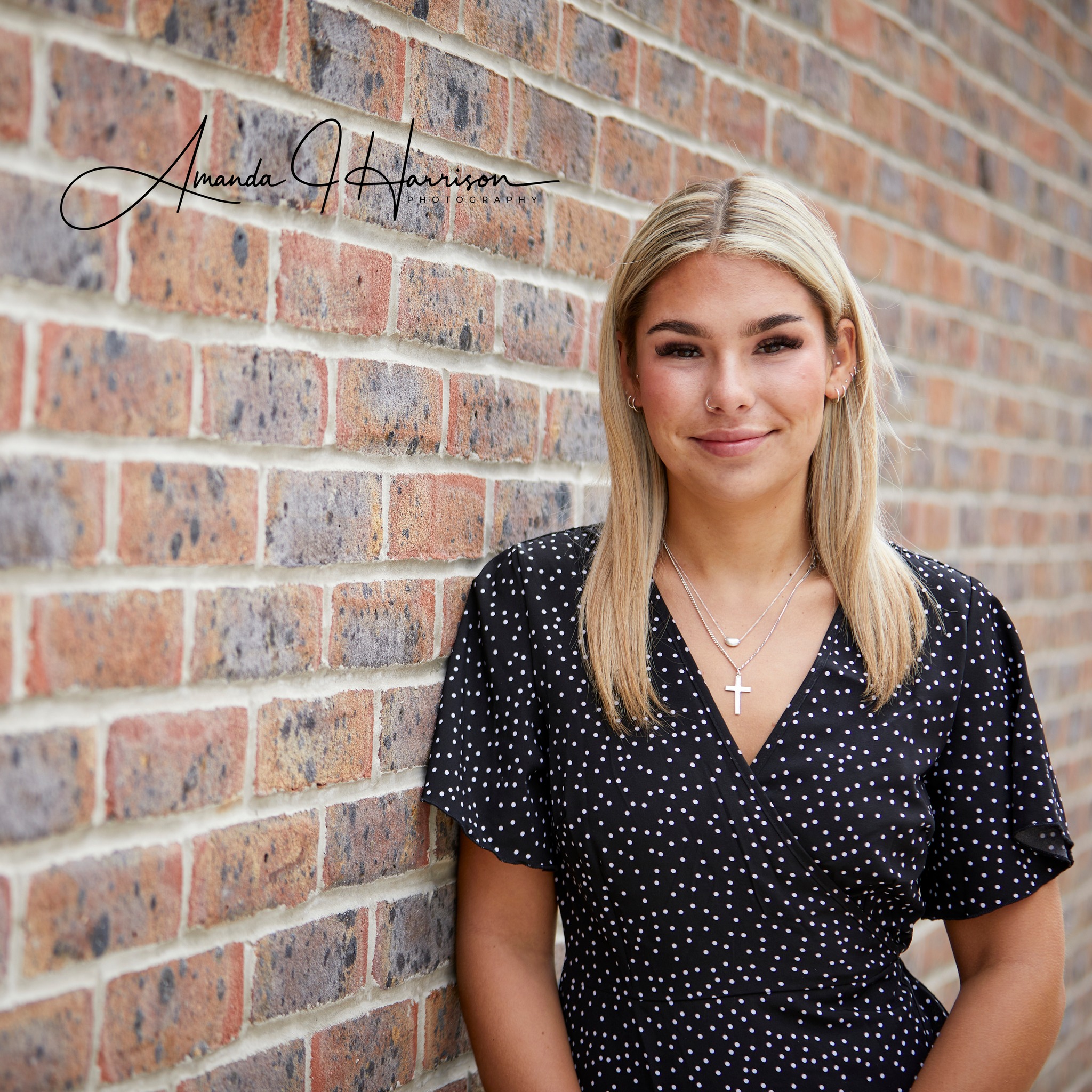 Corporate Headshot, lady stood next to a brick wall